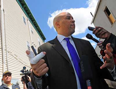 Newark Mayor Cory Booker talks to the media on Friday, April 13, 2012, about rescuing his neighbor from an apartment fire. (caption NorthJersey.com, photo credit ELIZABETH LARA / STAFF PHOTOGRAPHER)