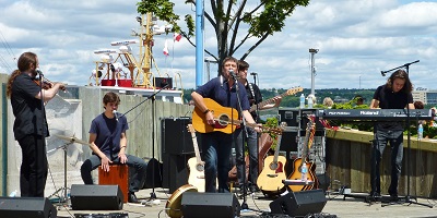 Lennie Gallant at the Halifax Tall Ships – Anthony Rissesco, violin; Jonathan Gallant, drum; Lennie Gallant, vocals and guitar; Mitchell Gallant, bass, Jeremy Gallant, keyboard (photo Stephen Pate)