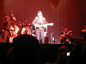 Leonard Cohen strapping on his guitar in Halifax 2013