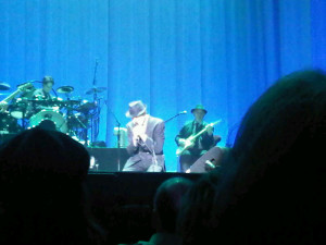  Leonard Cohen kneeling in performance, Halifax NS April 2013 (Blackberry photo)